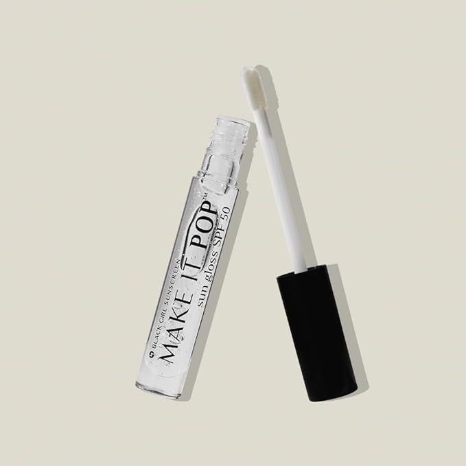 An open container of lip gloss labeled