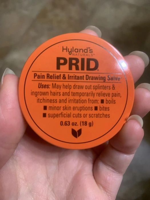 A tin of Hyland's Naturals PRID Pain Relief & Irritant Drawing Salve, designed to remove splinters, ingrown hairs, and ease pain from boils and minor skin irritations.
