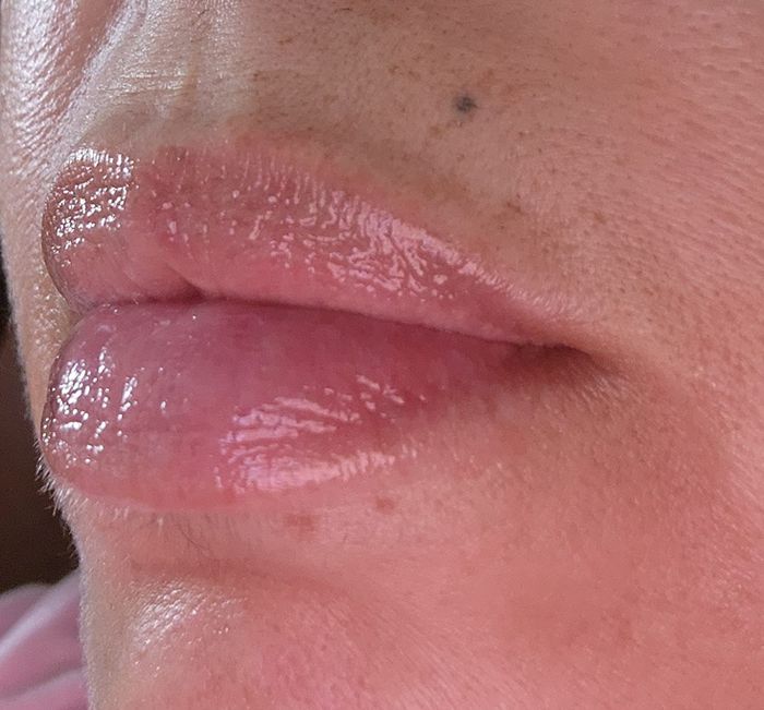 Close-up of a reviewer’s glossy lips