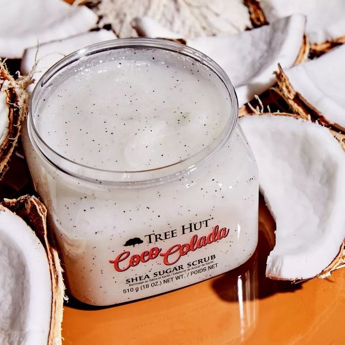 Tree Hut Coco Colada Shea Sugar Scrub in a clear jar surrounded by coconut halves
