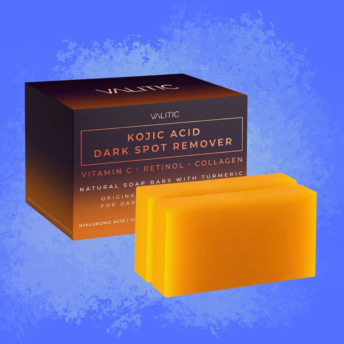 An image of the VALITIC Kojic Acid Dark Spot Remover box alongside two vibrant orange soap bars. The product boasts ingredients like Vitamin C, Retinol, Collagen, and Turmeric for skin brightening.