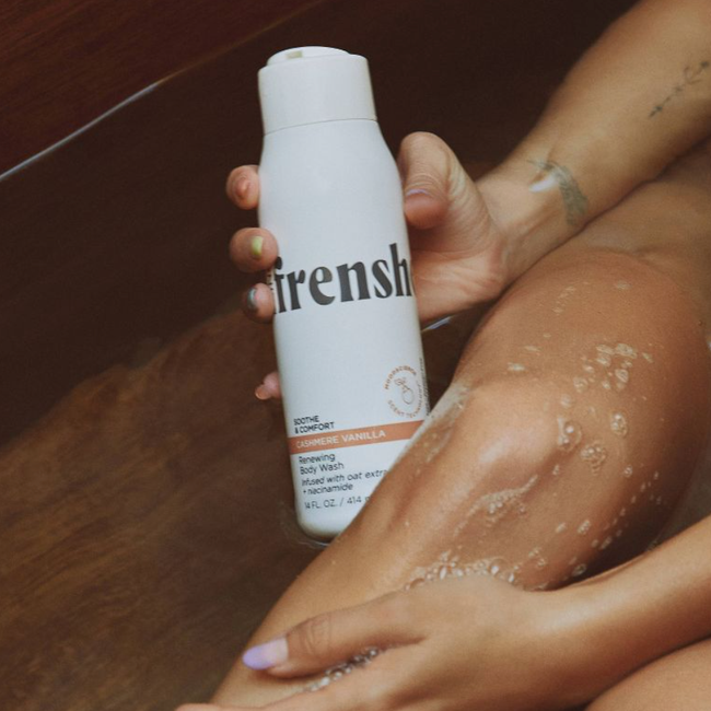 Model holding being frenshe renewing and hydrating body wash in the cashmere vanilla scent