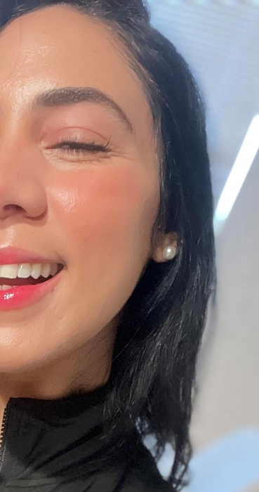 A close-up of the reviewer with dewy, glowing skin.