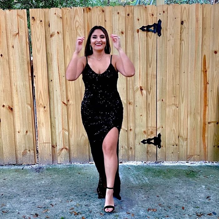 reviewer modeling a dazzling black sequin dress