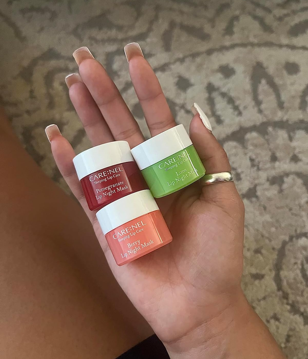 A reviewer displaying three different types of lip masks in hand
