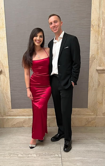 reviewer modeling a vibrant red dress