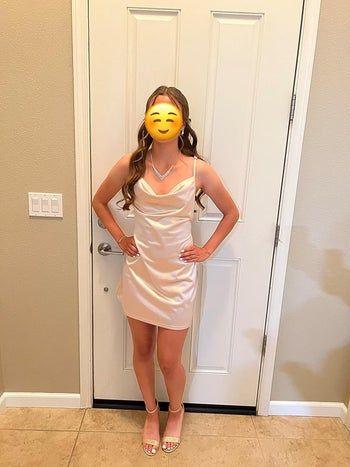 reviewer modeling a nude satin dress with a cowl neck