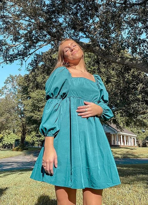 reviewer wearing the turquoise dress