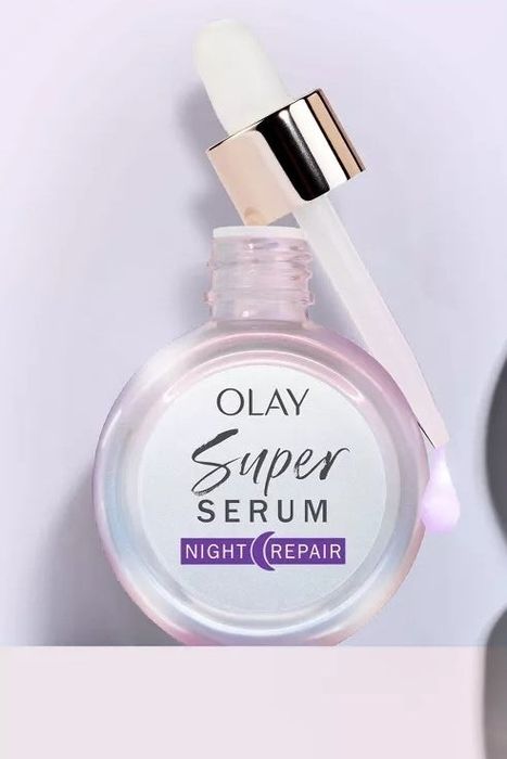 Olay Super Serum Night Repair bottle with a dropper, showcased against a simple background