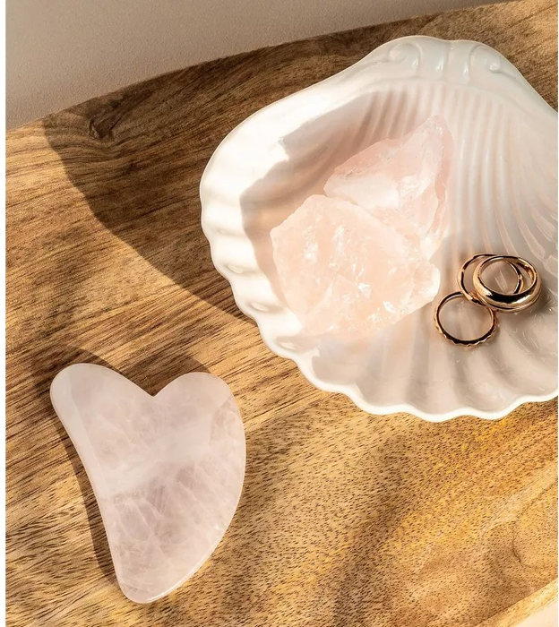 A rose quartz gua sha tool