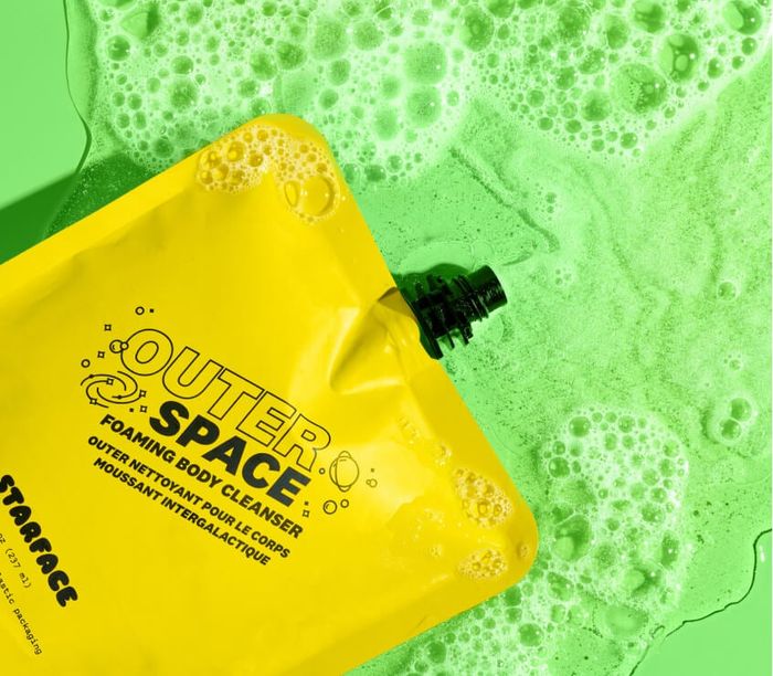 a bright yellow pouch of foaming body cleanser