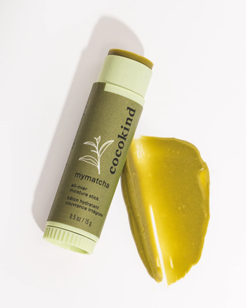 the matcha stick placed elegantly on a mound of matcha powder