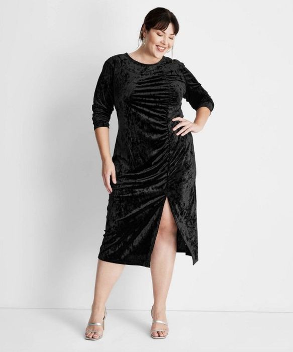 A long, elegant black velvet dress.