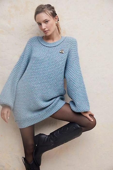 Model showcasing a blue cable-knit mini sweater dress