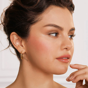 Selena Gomez using Rare Beauty liquid blush