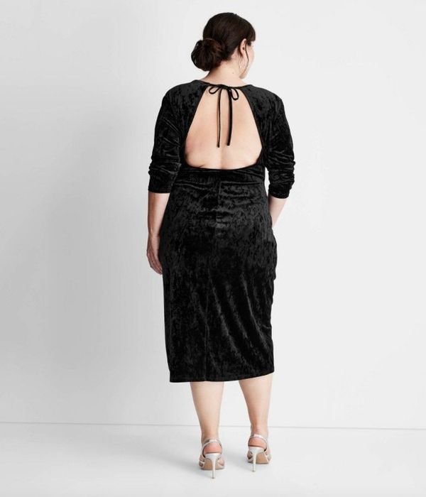 A stunning black velvet dress featuring an open back design.