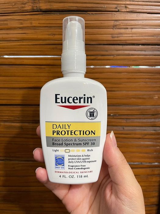 a reviewer holding the Eucerin hydrating sunscreen