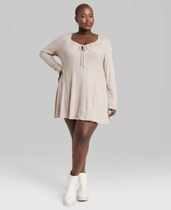 A cream-colored knit long sleeve dress, perfect for layering or wearing solo for a classic look.