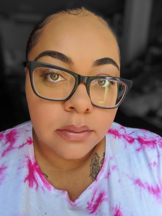 A reviewer showcasing their face fully made up after using the primer