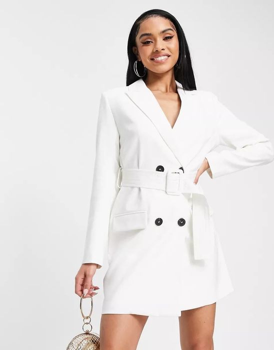 Model showcasing a long-sleeve white blazer dress