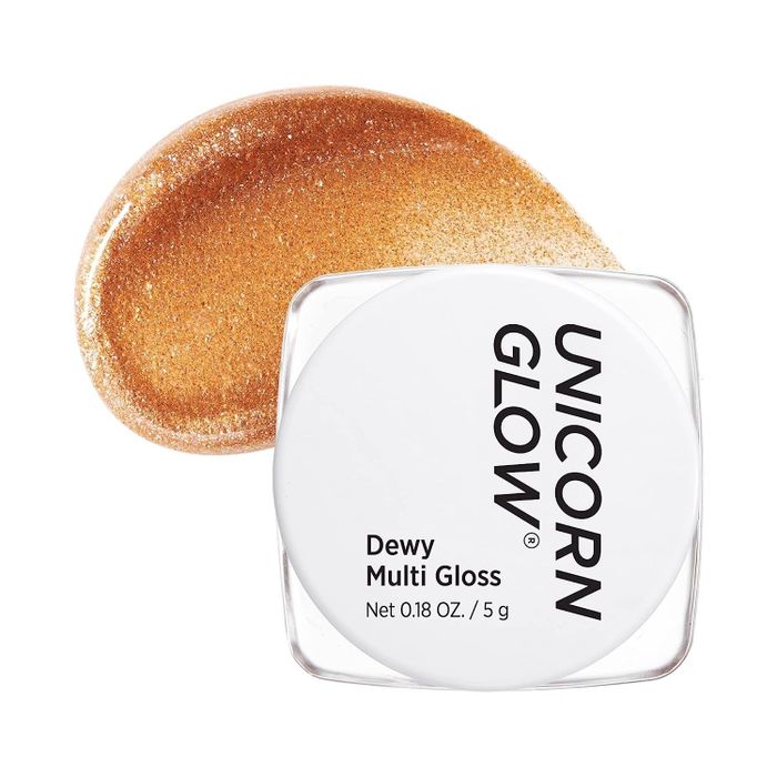 A gold gloss in sleek white packaging, ready to add a touch of shimmer to your face.