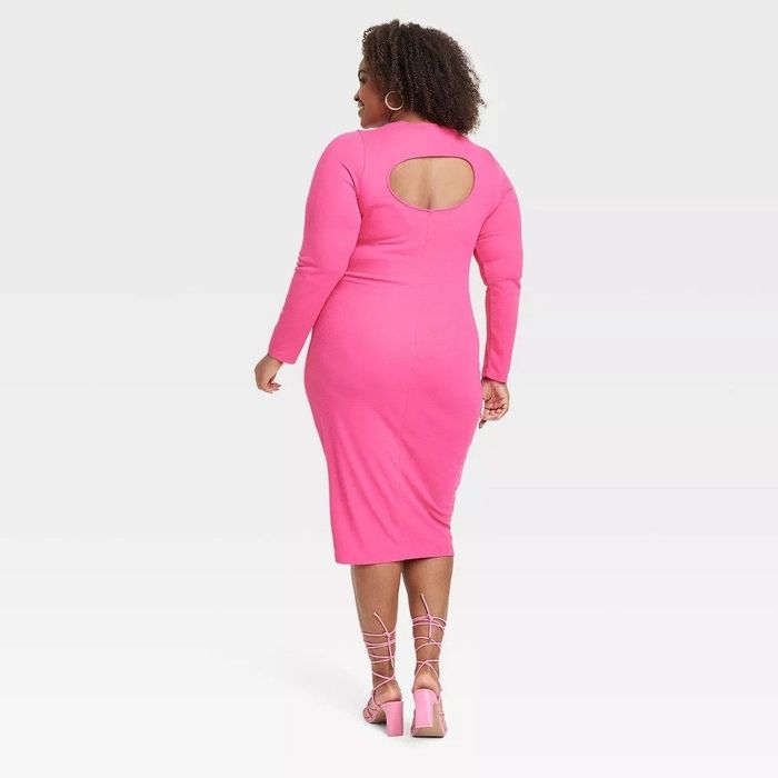Model showcasing the pink dress with an open back