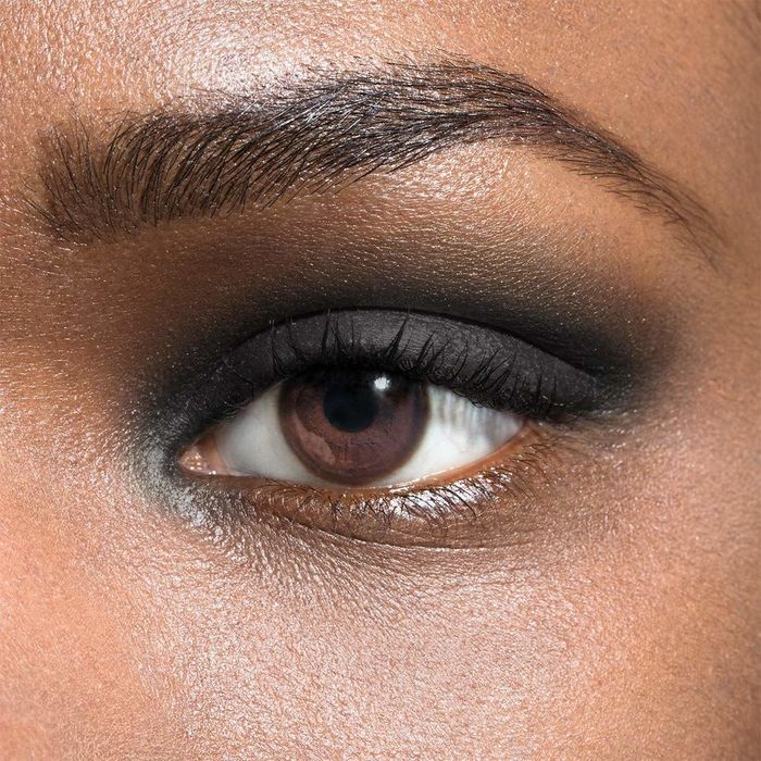 A model wearing Julep eye shadow in the rich shade of onyx, creating a bold and dramatic look.