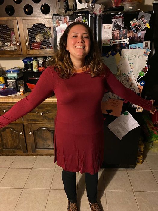 Reviewer wearing a long-sleeve burgundy T-shirt dress with black leggings