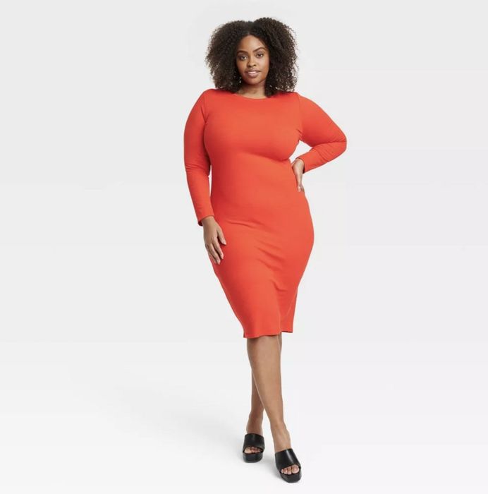 Model showcasing the red open-back bodycon dress
