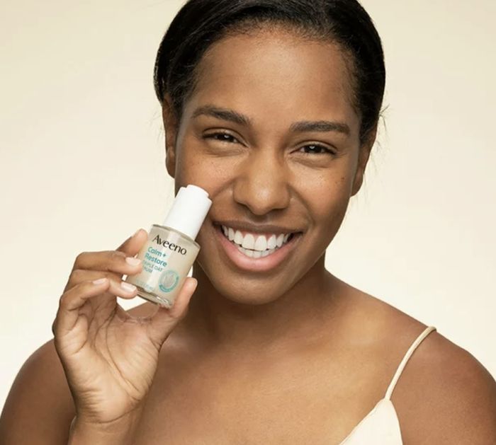 A person holding the serum in their hand, showcasing the product.