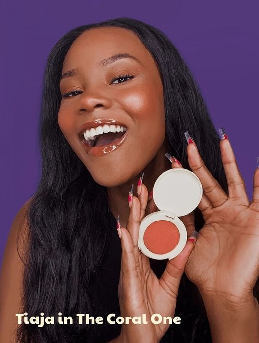 A model rocking a coral blush, adding that perfect touch of color.