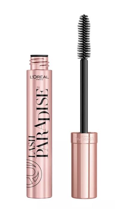 Mascara wand beside the tube