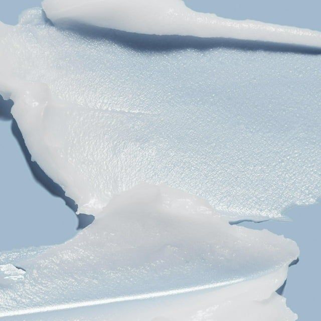The balm placed against a blue background.