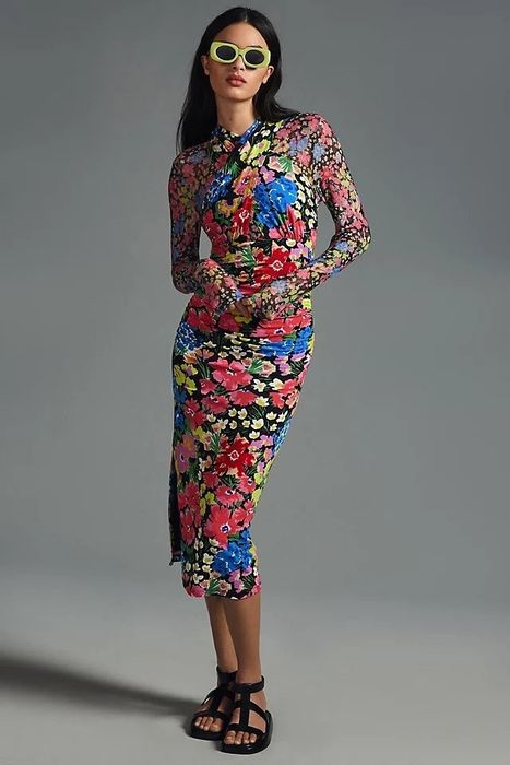 Model wearing a long mesh-sleeve multicolor floral dress