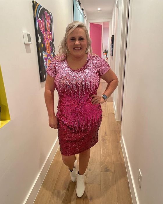 Reviewer showcasing a pink sequin dress