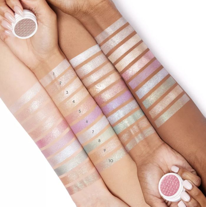 Four models of varying skin tones showcasing each color swatched on their arms