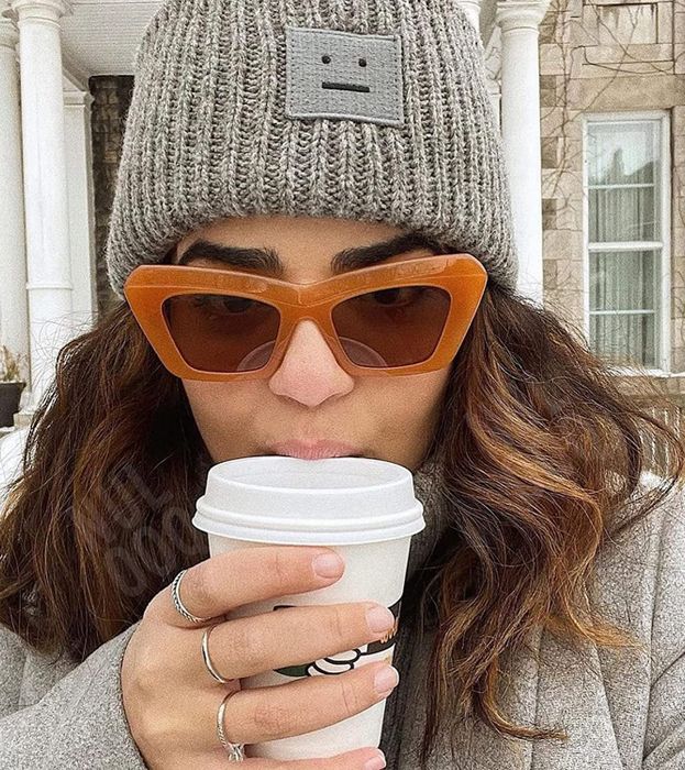another model wearing the amber-colored frames