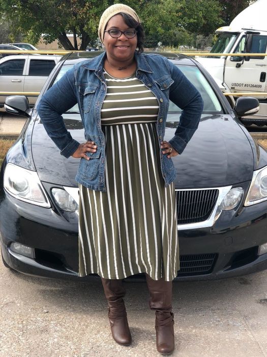 Reviewer wearing the green dress with boots and a denim jacket.