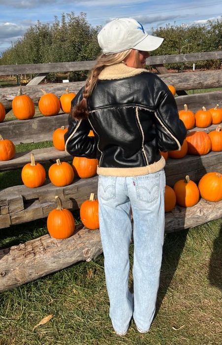 A reviewer modeling the same pair of jeans from the back