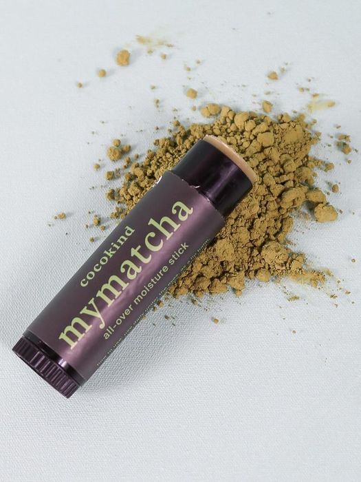 the matcha stick placed elegantly on a mound of matcha powder