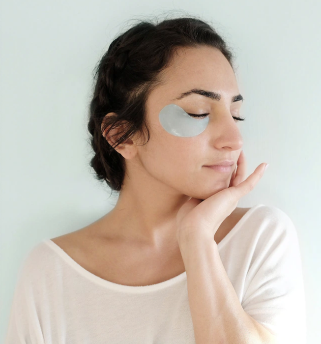 a model wearing the blue under-eye patches