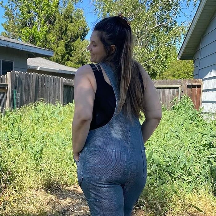 A reviewer modeling the stonewashed overalls