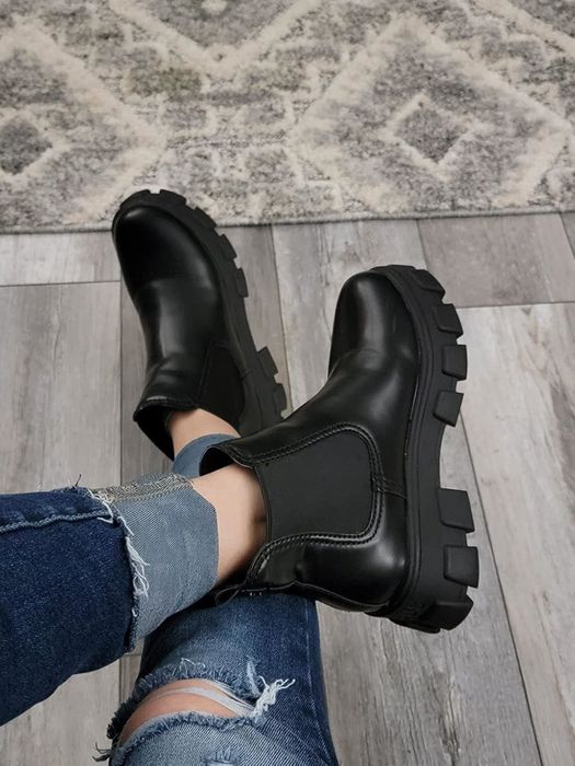 A reviewer showcasing the black boots