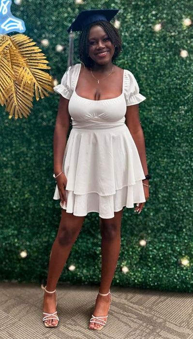 A reviewer modeling the white dress