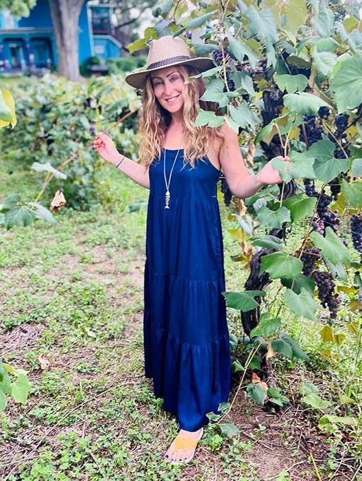 A reviewer showcasing the navy hat