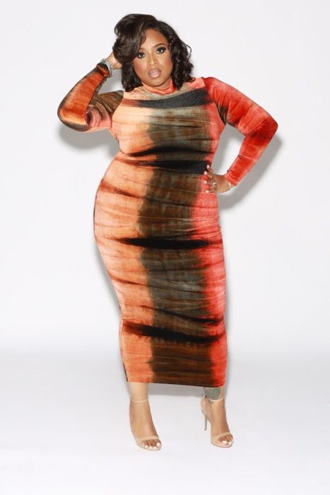 Model wearing the body-con dress with nude strappy stilettos.
