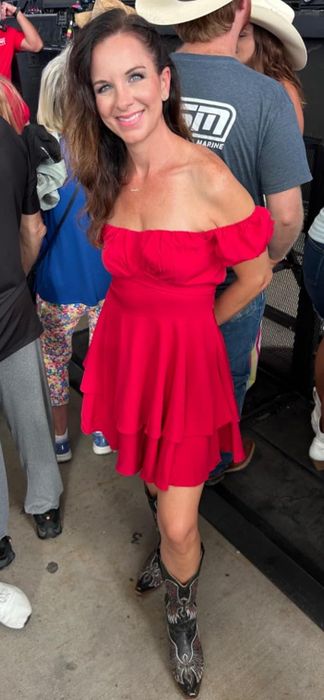 A reviewer showcasing the red dress