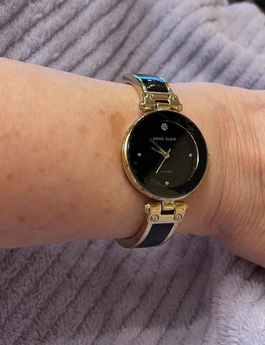 A photo of the black and gold watch