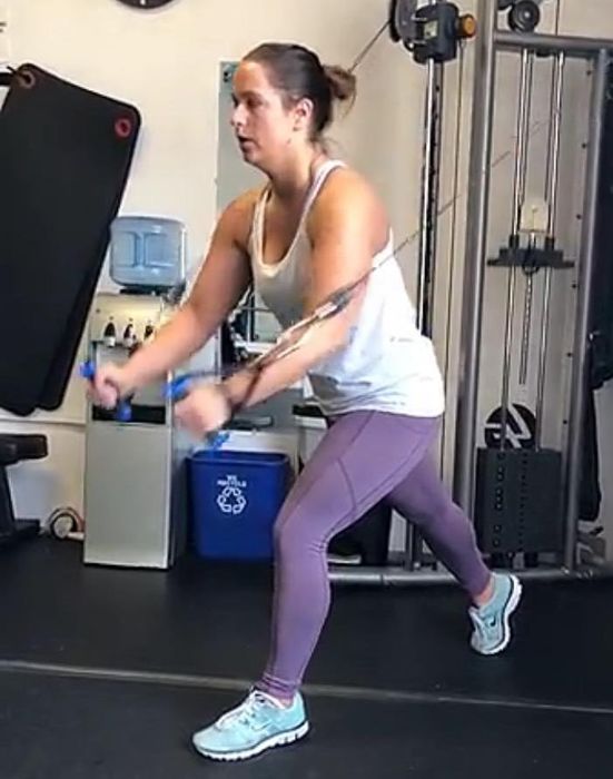 A fitness enthusiast actively exercising in the vibrant purple leggings