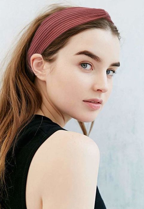 Model wearing a red knotted headband